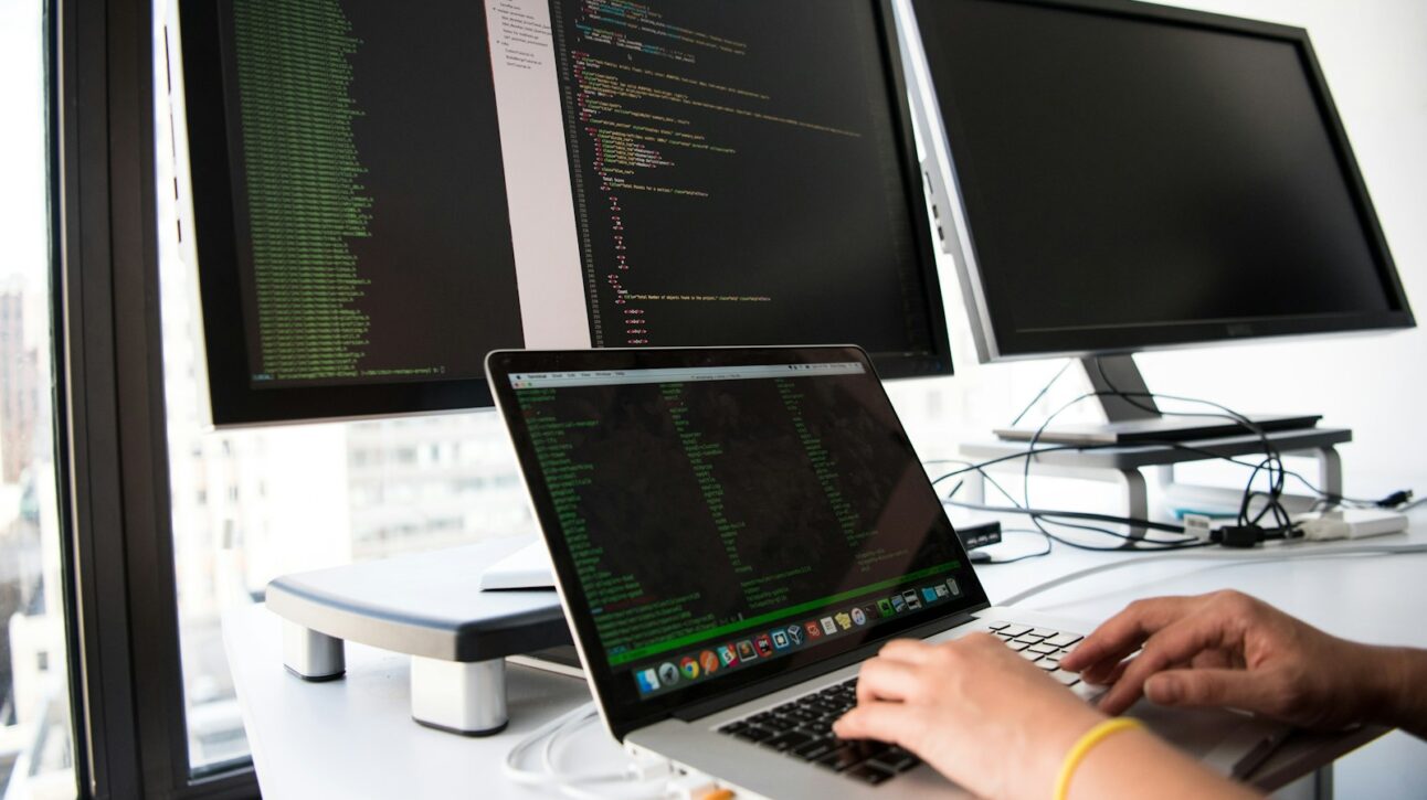 shallow focus photo of person using MacBook