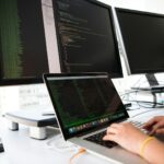 shallow focus photo of person using MacBook