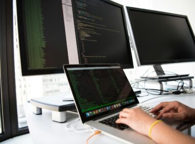shallow focus photo of person using MacBook
